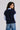 sleeveless roundneck vest with raveled thread on sleeve, neck